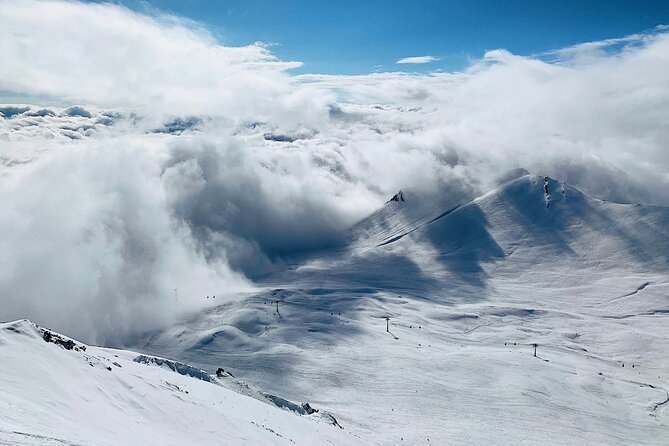 Private Effortless transfer from Tbilisi to Gudauri ski resort - Pickup in Tbilisi: airport sign, hotel door, and language help