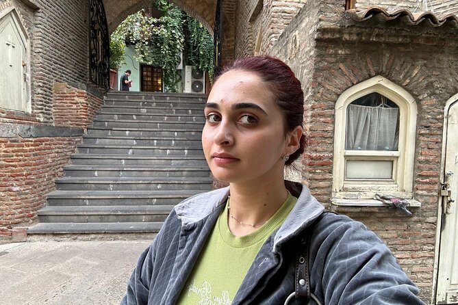 Tbilisi Old Town Walking Tour with a Local Guide - Rezo Gabriadze Marionette Theater and the clock tower face-off